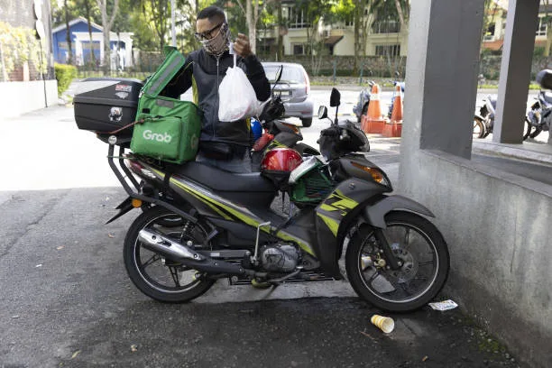 A GrabFood delivery rider packing an order in Kuala Lumpur